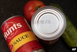 A "best by" date is seen on the top of a tomato sauce can, Aug. 20, 2022, in Boston.