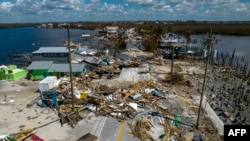 An aerial picture taken on Oct. 1, 2022, shows a broken section of the Pine Island Road, debris and destroyed houses in the aftermath of Hurricane Ian in Matlacha, Florida.