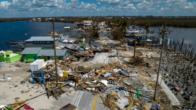 An aerial picture taken on Oct. 1, 2022 shows a broken section of the Pine Island Road, debris and destroyed houses in the aftermath of Hurricane Ian in Matlacha, Florida.