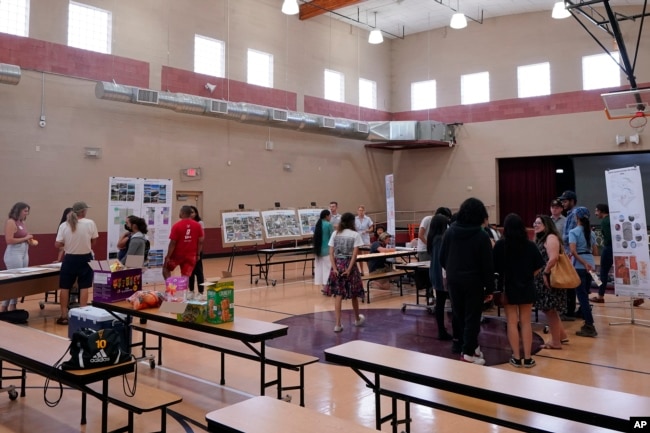 Residents attend an event hosted by Arizona State University graduate design students at Academia del Pueblo. (AP Photo/Matt York)