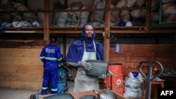 FILE: A technician working for the Solidarite Technologique company, poses for a portrait outside his workshop in Yaounde on September 16, 2022. 