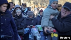 Local residents queue for water after about 80 percent of the inhabitants of the Ukrainian capital were left without water supply according to the mayor, after a Russian missile attack, as Russia's invasion of Ukraine continues, in Kyiv, Ukraine Oct. 31, 2022.