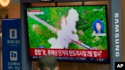 A TV screen showing a news report about North Korea's missile launch with file footage is seen at the Seoul Railway Station in Seoul, South Korea, Oct. 1, 2022. On Saturday, North Korea fired two short-range ballistic missiles. (AP Photo/Lee Jin-man) 