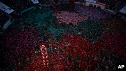 Members of &quot;Jove de Xiquets de Valls&quot; form their human tower during the 28th Human Tower Competition in Tarragona, Spain.
