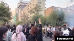 Women raising their fists in defiance of Iran's harshly conservative religious regime as protests for the regime's removal continue. Taken October 30, 2022