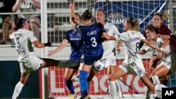 FILE - Racing Louisville FC's Erin Simon, left, and Freja Olofsson (8) defend against North Carolina Courage's Kaleigh Kurtz (3) in an NWSL soccer match in Cary, N.C., Oct. 6, 2021.