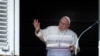 Pope Francis waves from the window of the Apostolic Palace during the weekly Angelus prayer on Oct. 2, 2022 in the Vatican.