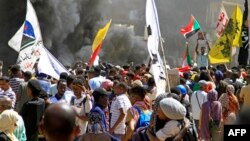 Demonstrators march in a protest in the area of Bashdar, in Khartoum, Sudan, Oct. 25, 2022, on the first anniversary of the military's arrest of the civilian administration. Security forces shot tear gas to try to disperse thousands of pro-democracy prote