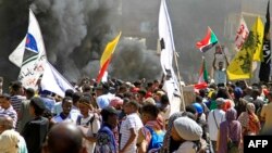 Demonstrators march in a protest in the area of Bashdar, in Khartoum, Sudan, Oct. 25, 2022, on the first anniversary of the military's arrest of the civilian administration. Security forces fired tear gas to try to disperse thousands of pro-democracy protesters.