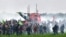 Activists walk among tear gas following clashes with riot mobile gendarmes during a demonstration against the "basins" near the construction site of a new water reserve for agricultural irrigation, in Sainte-Soline, western France, on Oct. 29, 2022.