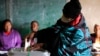 A woman covered with a blanket casts her vote at a poling station in Maseru, Lesotho, Oct. 7, 2022. 