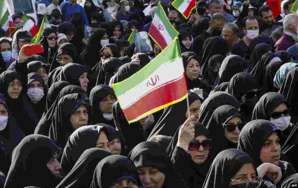 Iranians take part in a pro-government rally in Tajrish square north of Tehran, condemning recent anti-government protests over the death of Mahsa Amini while in custody of the morality police.