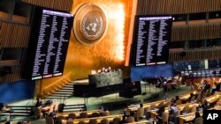 FILE - Video monitors show member nation votes in the United Nations General Assembly in favor of a resolution condemning Russia's illegal referendum in Ukraine, Oct. 12, 2022 at U.N. headquarters.