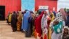 FILE - Somali women and children who left rural areas due to drought receive nutritional assistance at a camp for the internally displaced, on the outskirts of Baidoa, Somalia, Oct. 12, 2022.