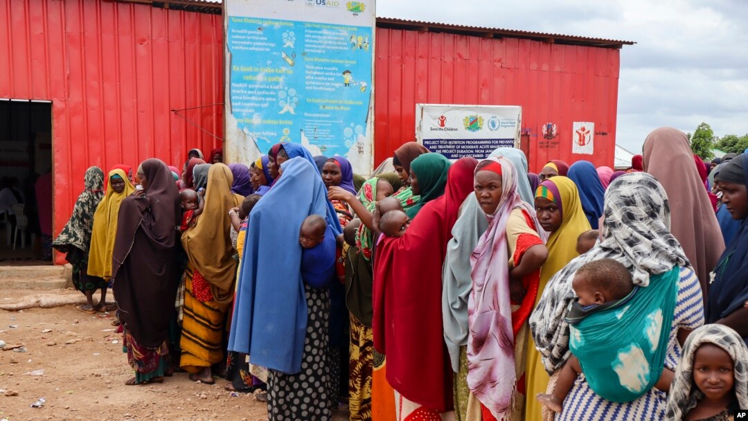 Somali women and children who left rural areas due to drought receive nutritional assistance at a camp for the internally displaced, on the outskirts of Baidoa, Somalia, Oct. 12, 2022.