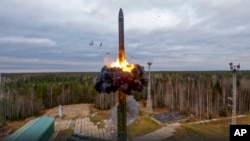 In this handout photo from video released by Russian Defense Ministry Press Service on Oct. 26, 2022, a Yars intercontinental ballistic missile is test-fired as part of Russia's nuclear drills from a launch site in Plesetsk, northwestern Russia.