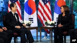 South Korea's Prime Minister Han Duck-soo, left, listens as U.S. Vice President Kamala Harris speaks during a bilateral meeting in Tokyo, Sept. 27, 2022.