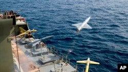 FILE - In this photo released by the Iranian Army on Aug. 25, 2022, a drone is launched from a warship in a military drone drill in Iran.