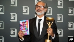 Author Shehan Karunatilaka holds the Booker Prize after the announcement of the honor for his novel, "The Seven Moons of Maali Almeida" in London, Oct. 17, 2022.