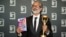 Author Shehan Karunatilaka holds the Booker Prize after the announcement of the honor for his novel, "The Seven Moons of Maali Almeida" in London, Oct. 17, 2022.
