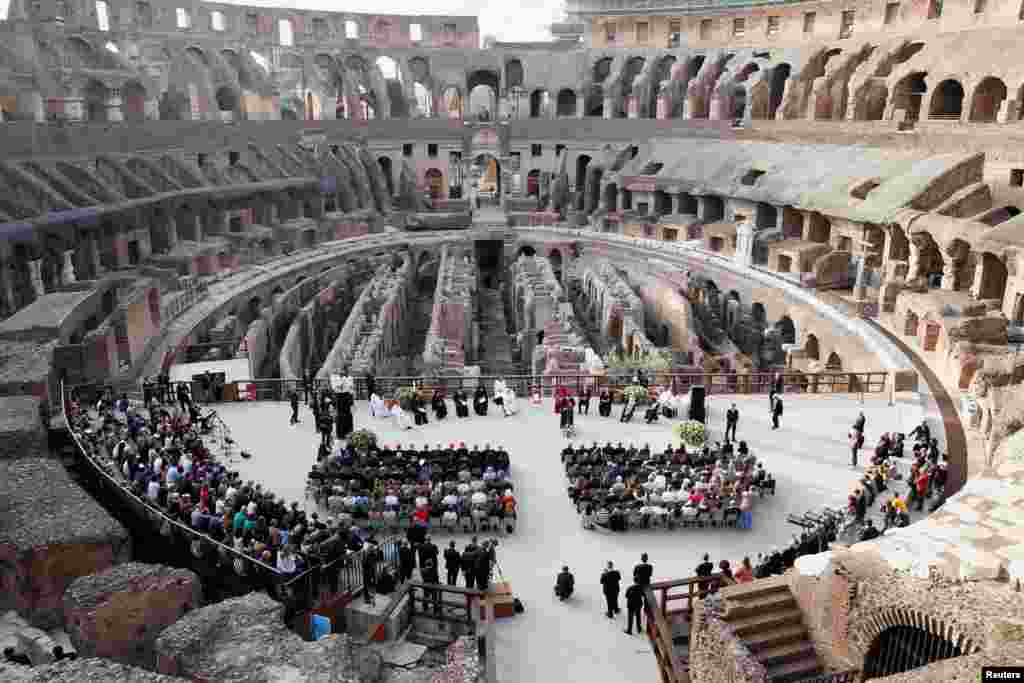 People attend an inter-religious prayer for peace led by Pope Francis, at the Colosseum in Rome, Italy.