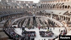 People attend an inter-religious prayer for peace led by Pope Francis, at the Colosseum in Rome, Italy.