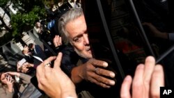 Steve Bannon, center, a longtime ally of former President Donald Trump and convicted of contempt of Congress, leaves the federal courthouse in Washington. Bannon was sentenced to 4 months behind bars for defying January 6 committee subpoena.