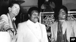 FILE - This Jan. 23, 1986, photo shows, from left, Jerry Lee Lewis, Fats Domino and James Brown at a reception where they were inducted into the Rock and Roll Hall of Fame at the Waldorf-Astoria Hotel in New York.