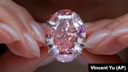 Berlian Pink Star", berlian potong paling berharga yang pernah ditawarkan di lelang, dipajang oleh seorang model di ruang lelang Sotheby's di Hong Kong. (Foto: AP/Vincent Yu)