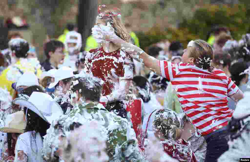 Students from St. Andrews University are covered in foam as they take part in the traditional &quot;Raisin Weekend&quot; in the Lower College Lawn, at St Andrews in Scotland, Britain.