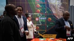 FILE - Delegates network during the Africa Oil Week conference, Oct. 4, 2022, in Cape Town, South Africa.