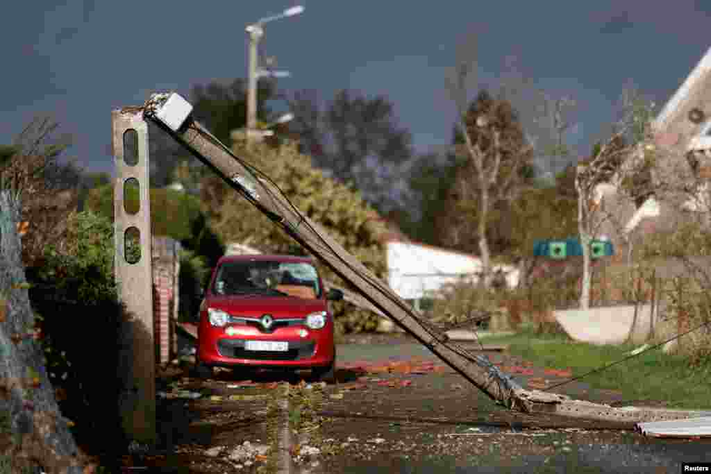 A damaged utility pole is seen in Bihucourt, northern France, after a tornado hit the region.
