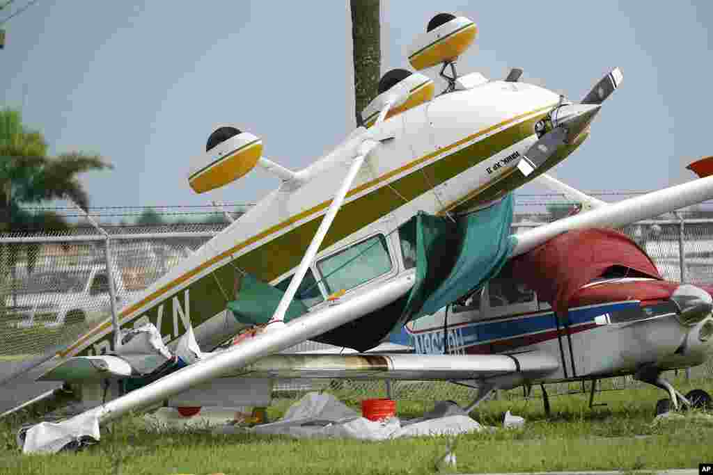 An airplane overturned by a likely tornado produced by the outer bands of Hurricane Ian sits at North Perry Airport in Pembroke Pines, Florida.
