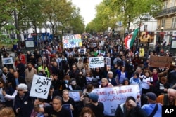 Demonstrators march in Paris, Oct. 2, 2022, to show support for Iranian protesters standing up to their leadership over the death of a young woman in police custody.