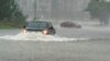 One motorist drives though high water as another turns around during the effects of Hurricane Ian, Sept. 30, 2022, in Charleston, S.C.