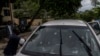 FILE - Bullet holes cover the windshield of a journalist's car after he was attacked in Port-au-Prince, Haiti, Oct. 25, 2022. Attacks on journalists in Haiti have increased in the summer of 2023.