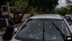 Bullet holes cover the windshield of journalist Roberson Alphonse's car after he was attacked in Port-au-Prince, Haiti, on Oct. 25, 2022. Alphonse, who works at the newspaper Le Nouvelliste and radio station Magik9, is hospitalized and said to be in stable condition.
