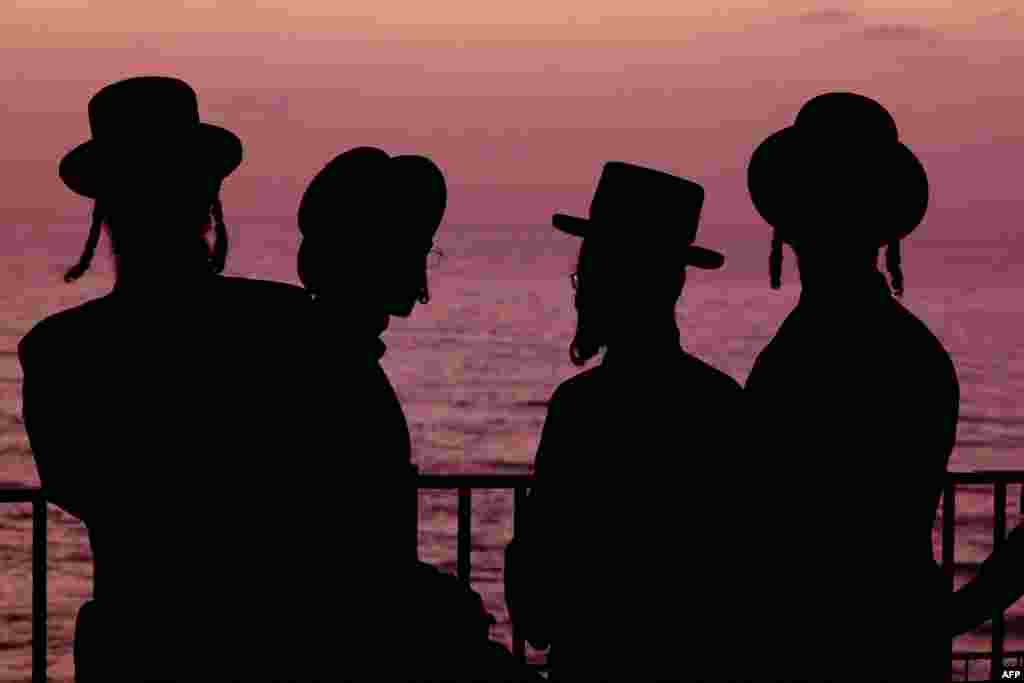 Ultra-Orthodox Jewish men and children perform the &quot;Tashlich&quot; ritual, during which &quot;sins are cast into the water to the fish,&quot; ahead of the Day of Atonement, or Yom Kippur, the most important day in the Jewish calendar, which this year will start at sunset on October 4, in the coastal Mediterranean city of Netanya, Israel.