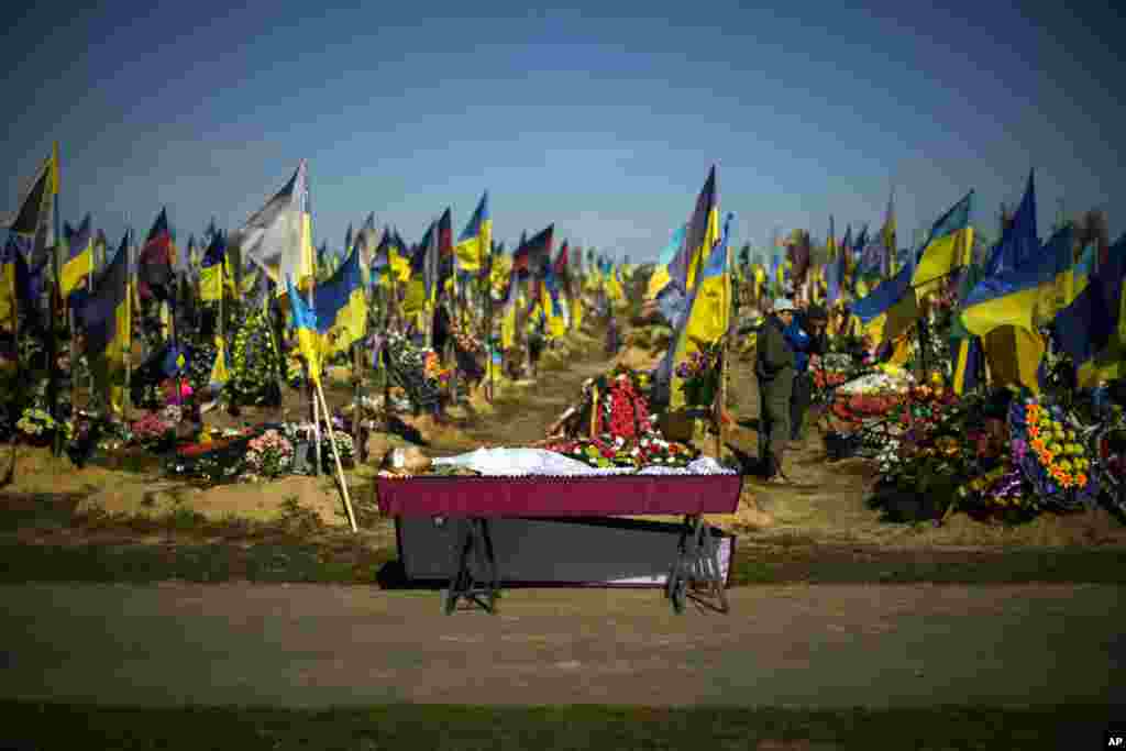 The body of recently killed Ukrainian serviceman Vadim Bereghnuy, 22, rests in a coffin during his funeral in a cemetery in Kharkiv, Ukraine.