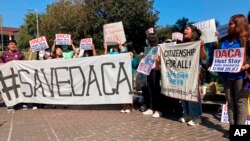 A group of community activists and others gathered Oct. 14, 2022, in a park next to a federal courthouse in Houston in support of federal policy preventing the deportation of hundreds of thousands of migrants who were brought to U.S. when they were children.