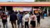 People gather outside of a daycare center, a scene of a mass shooting in the town of Uthai Sawan, 500 km (310 miles) northeast of Bangkok in the province of Nong Bua Lamphu, Thailand, Oct. 6, 2022