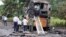 People inspect a bus that caught fire on a highway in Nashik, in the western Indian state of Maharashtra, Oct. 8, 2022.