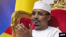 Mahamat Idriss Deby applauds as he is sworn in as Chad's transitional president, in N'Djamena on October 10, 2022