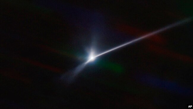 This image made available by NOIRLab shows a plume of dust and debris blasted from the surface of the asteroid Dimorphos by NASA's Dart spacecraft after it impacted on Sept. 26, 2022, captured by the U.S. National Science Foundation's NOIRLab's SOAR telescope in Chile. (Teddy Kareta, Matthew Knight/NOIRLab via AP)