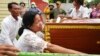 The mother of Son Sophat, a teen victim of a boat accident, cries by her daughter's coffin during a funeral procession in Koh Chamroeun village, eastern Phnom Penh, Cambodia, Oct. 14, 2022. 