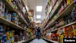 FILE - A woman shops for groceries at El Progreso Market in the Mount Pleasant neighborhood of Washington, D.C., Aug. 19, 2022.