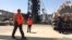 Workers stand at the Khurais oil field in Khurais, Saudi Arabia, Sept. 20, 2019. The OPEC+ coalition on Oct. 5, 2022, slashed production by 2 million barrels a day.