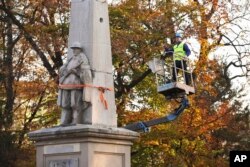 A worker stands on a crane to dismantle a Red Army monument in Glubczyce, Poland, Oct. 27, 2022. Poland dismantled four communist-era monuments to Red Army soldiers in a renewed drive to remove symbols of Moscow’s post-World War II domination and to stress its condemnation of Moscow’s current war on neighbouring Ukraine.