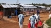 Medical attendants walk outside the Ebola isolation section of Mubende Regional Referral Hospital, in Mubende, Uganda, Sept. 29, 2022.
