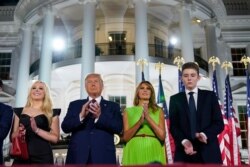 From left, Tiffany Trump, President Donald Trump, first lady Melania Trump and Barron Trump stand on stage on the South Lawn of the White House on the fourth day of the Republican National Convention, Aug. 27, 2020.